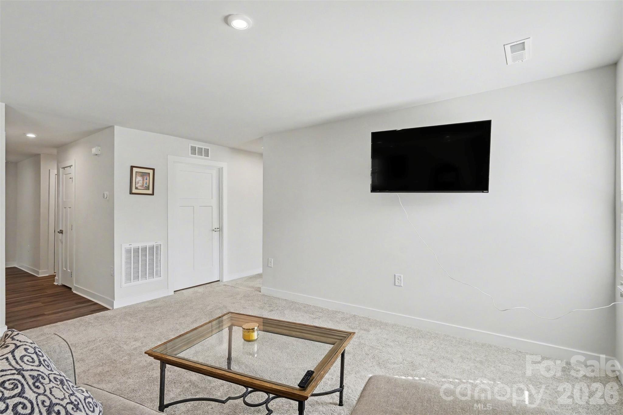 621 Grandiflora Avenue Lancaster, SC 29720 - Photo 29 of 37 a living room with a flat screen tv and a lamp
