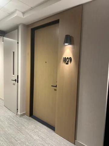 a view of a hallway with wooden floor and closet