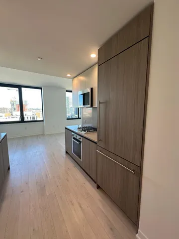 a kitchen with stainless steel appliances a refrigerator and a stove top oven