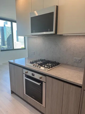 a kitchen with a stove and a microwave