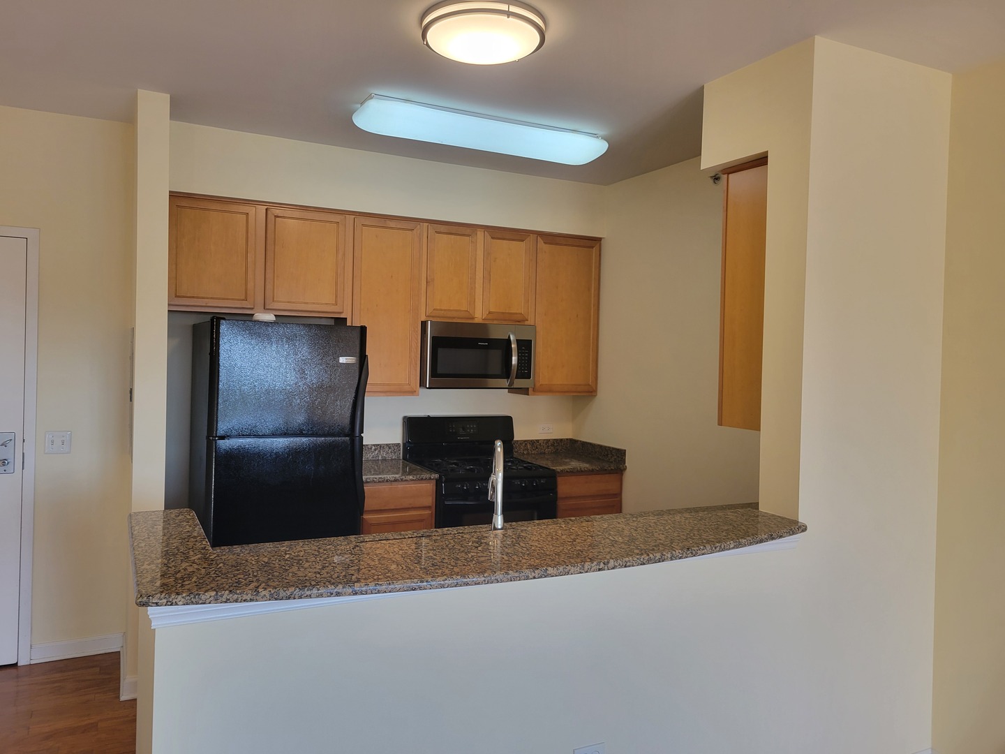 50 South Grove Avenue, Unit 510 Elgin, IL 60120 - Photo 3 of 7 a kitchen with a refrigerator and a sink