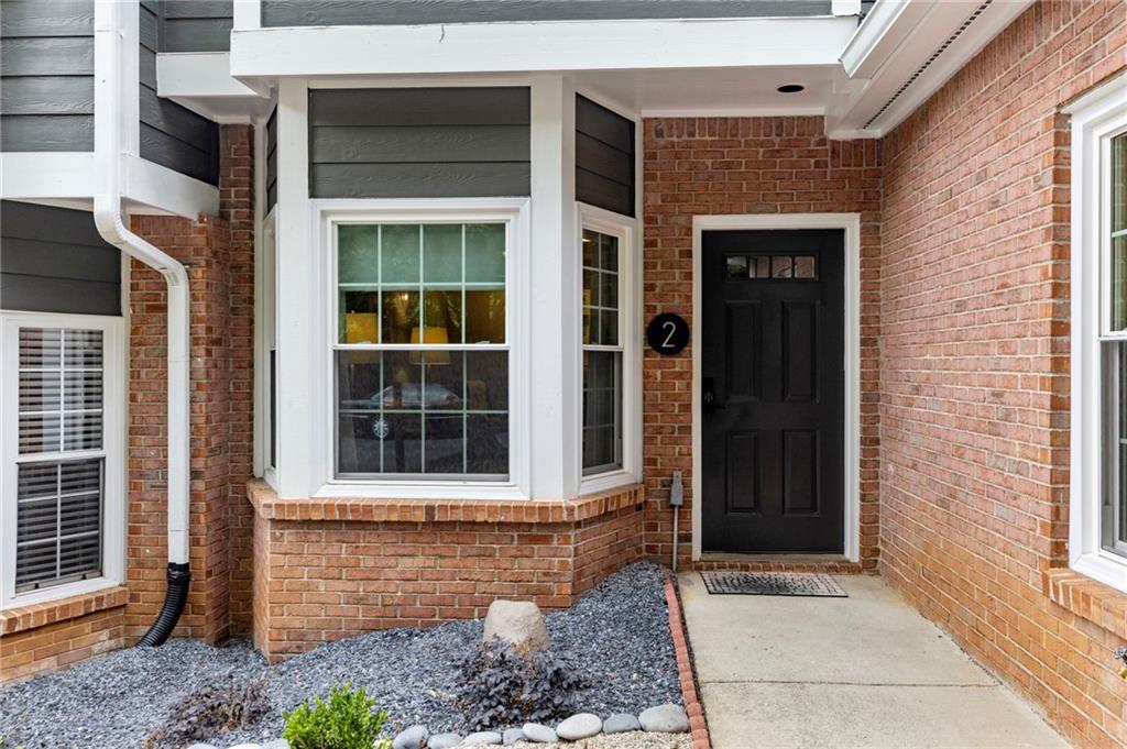 a front view of a house with a window and a glass door
