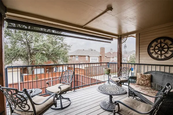 a balcony with furniture and a large window