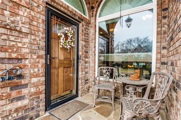 a view of a balcony with chairs and table