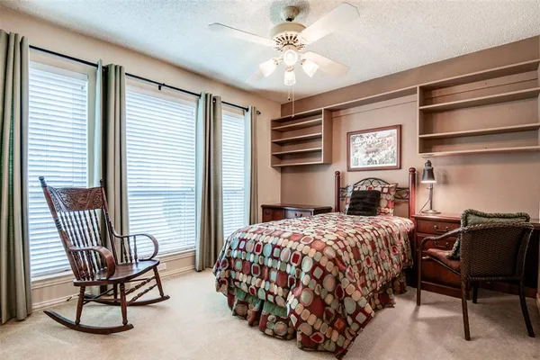 a bedroom with a bed chair and a window