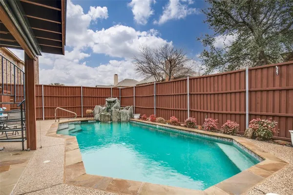 a front view of a house with swimming pool having outdoor seating