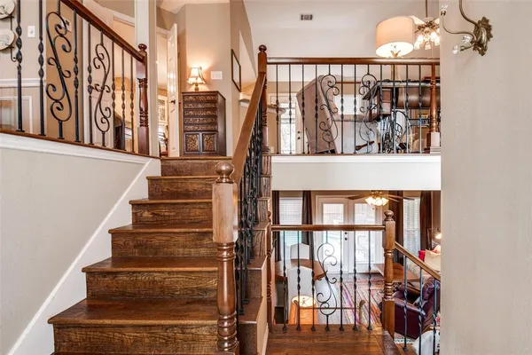 a view of entryway and hall with wooden floor