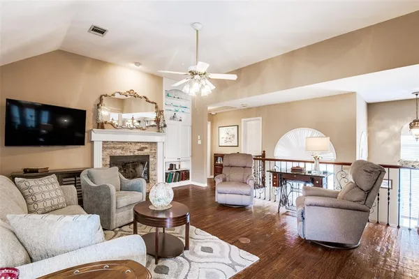a living room with furniture a fireplace and a flat screen tv