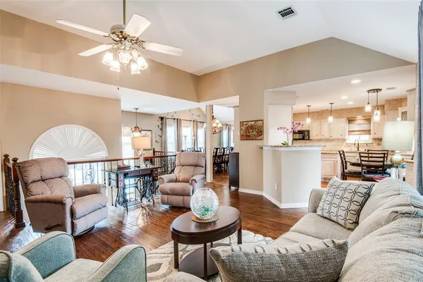 a living room with furniture and a chandelier