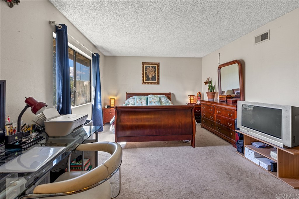 16874 Donwest, Unit 75 Tustin, CA 92780 - Photo 15 of 23 a living room with furniture and a flat screen tv