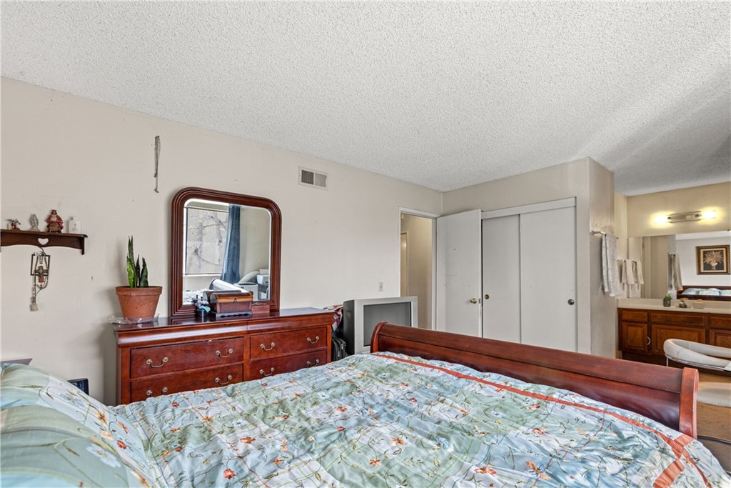 16874 Donwest, Unit 75 Tustin, CA 92780 - Photo 16 of 23 a bedroom with a bed and a dresser