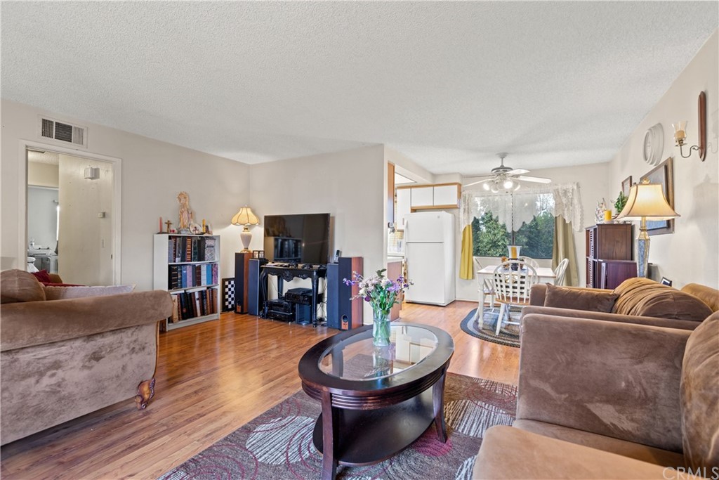 16874 Donwest, Unit 75 Tustin, CA 92780 - Photo 8 of 23 a living room with furniture a flat screen tv and a large window
