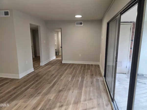 a view of a room with wooden floor and sliding door