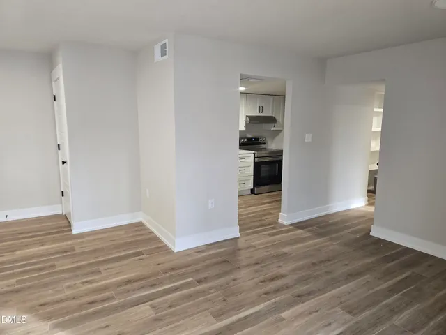 a view of a kitchen with wooden floor and a sink