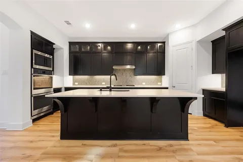 a kitchen with a sink and wooden cabinets