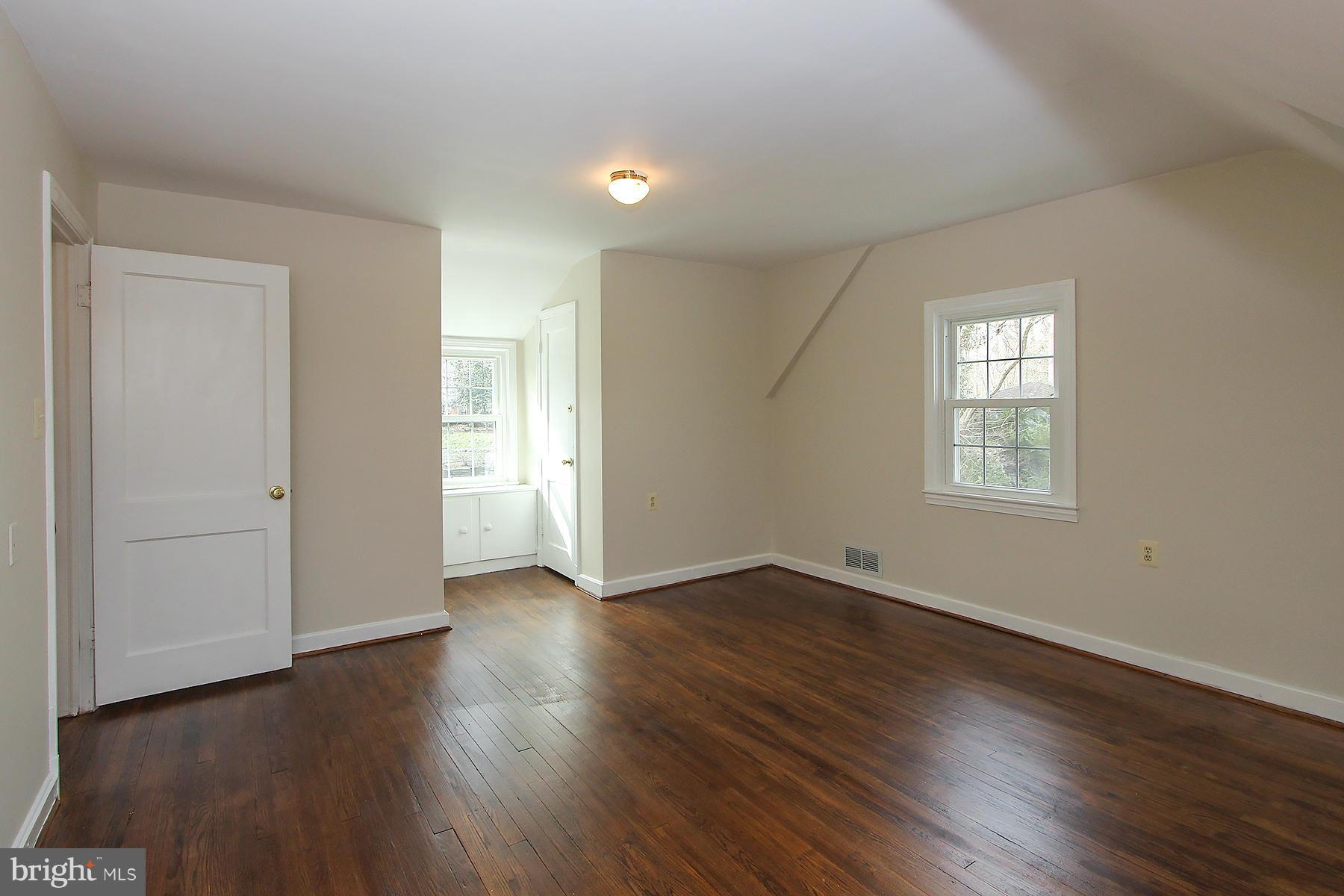 1111 Notley Road Silver Spring, MD 20904 - Photo 23 of 30 a view of an empty room with wooden floor and a window