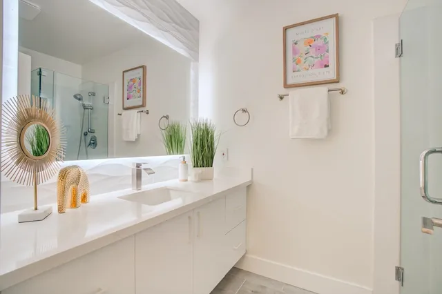 a bathroom with a sink and a mirror with painted walls