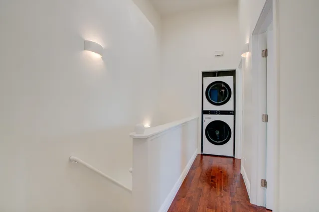 a view of a hallway with washer and dryer