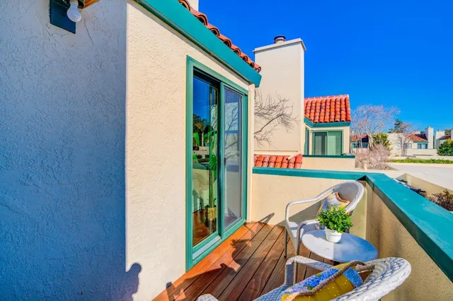 a balcony with furniture and a potted plant
