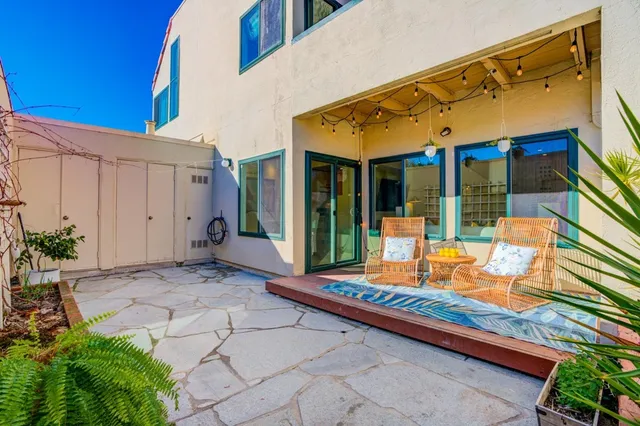 a backyard of a house with barbeque oven table and chairs