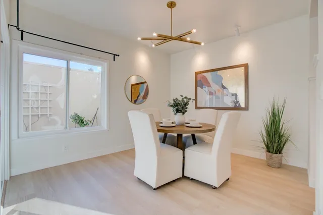 a view of a dining room with furniture window and wooden floor