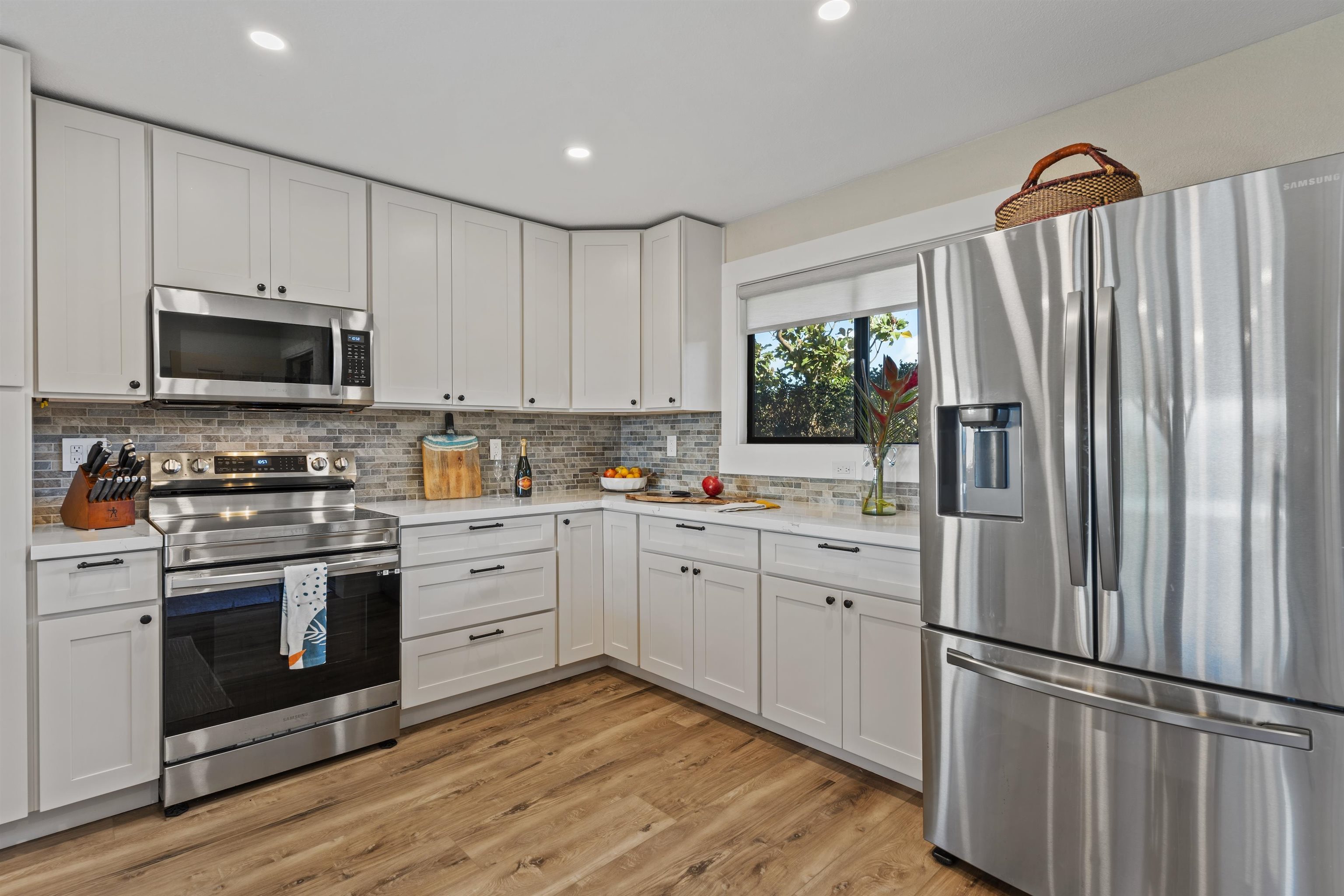 150 Puukolii Road, Unit 43 Lahaina, HI 96761 - Photo 5 of 31 a kitchen with white cabinets stainless steel appliances and a window