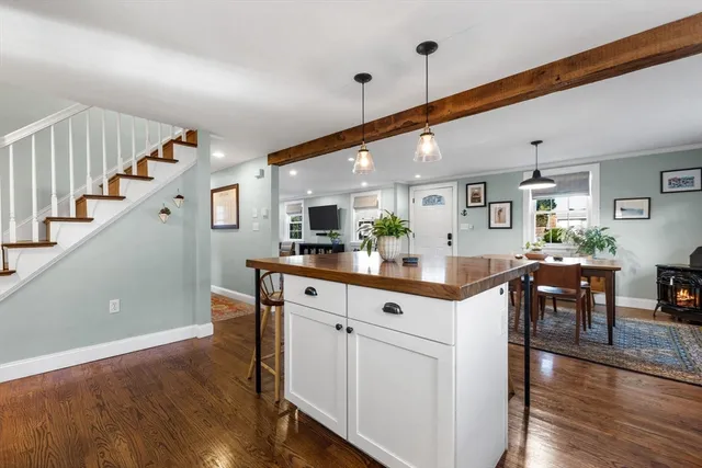 a kitchen with cabinets and chairs