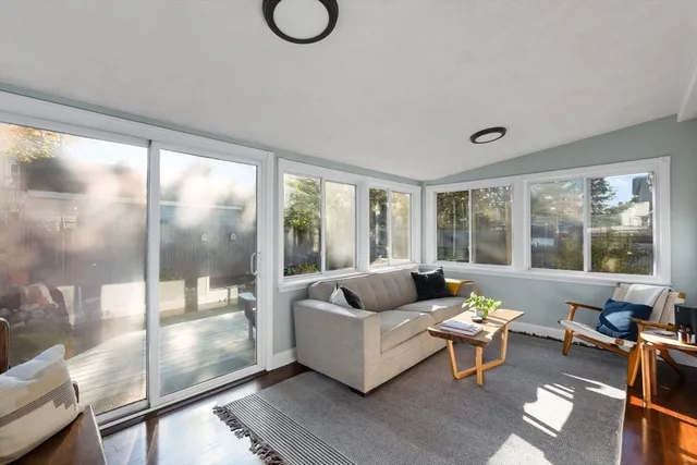 a living room with furniture and a floor to ceiling window