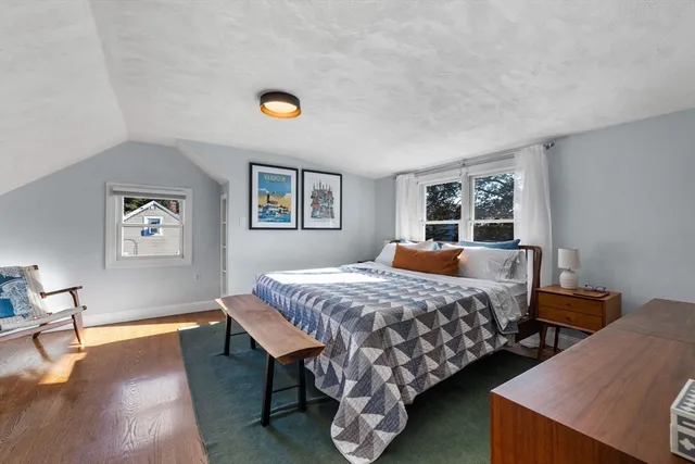 a bedroom with bed and a window