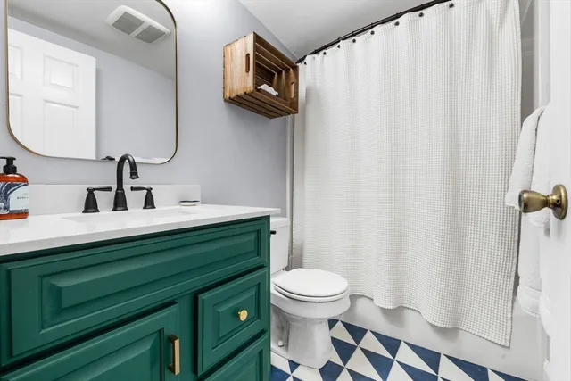 a bathroom with a sink a toilet and a mirror