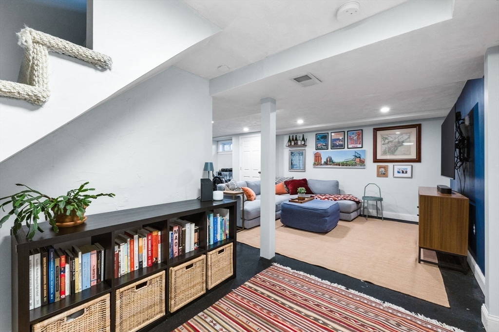 13 Parsons Drive Beverly, MA 01915 - Photo 21 of 31 a living room with furniture and a book shelf