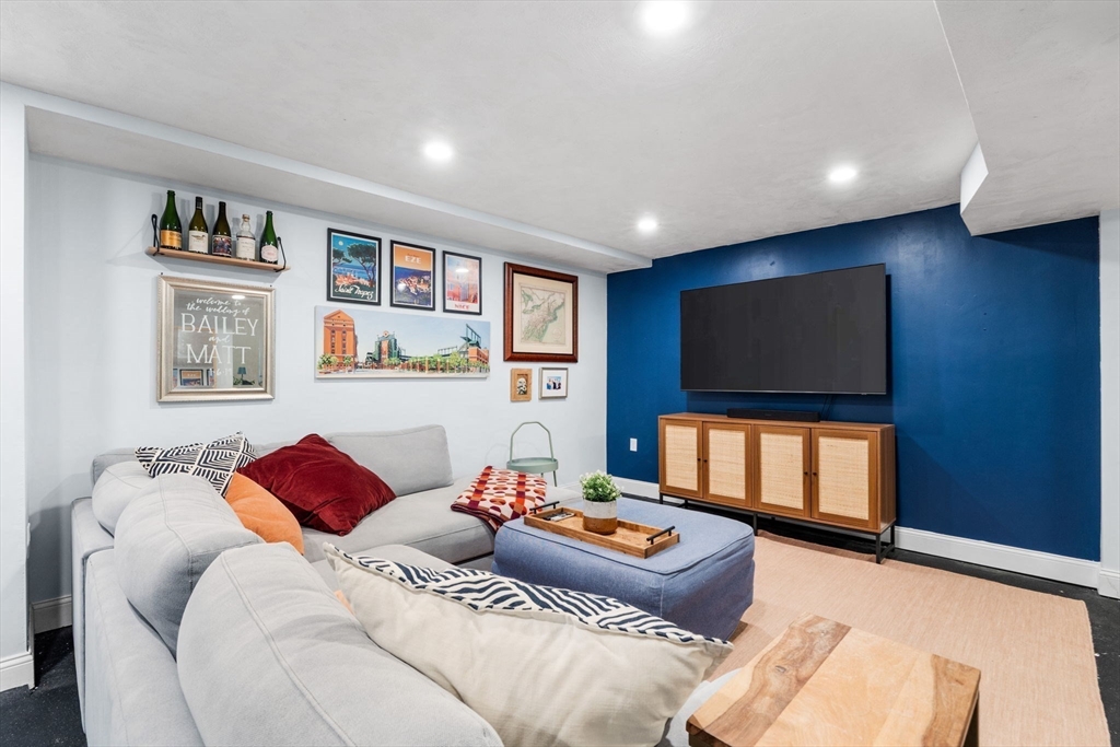 13 Parsons Drive Beverly, MA 01915 - Photo 22 of 31 a living room with a couch and a flat screen tv