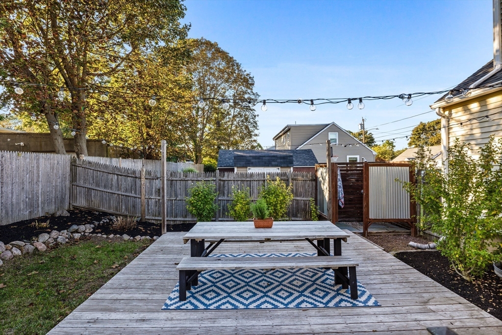 13 Parsons Drive Beverly, MA 01915 - Photo 26 of 31 a view of a patio with table and chairs with wooden fence and plants