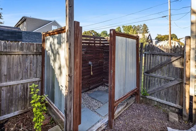 a view of a house with a glass door and wooden floor