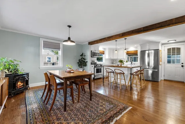 a dining room with furniture window and wooden floor