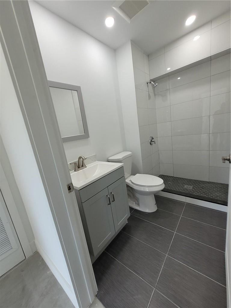 6041 Southwest 17th Street Miami, FL 33155 - Photo 16 of 26 a bathroom with a double vanity sink toilet and a shower