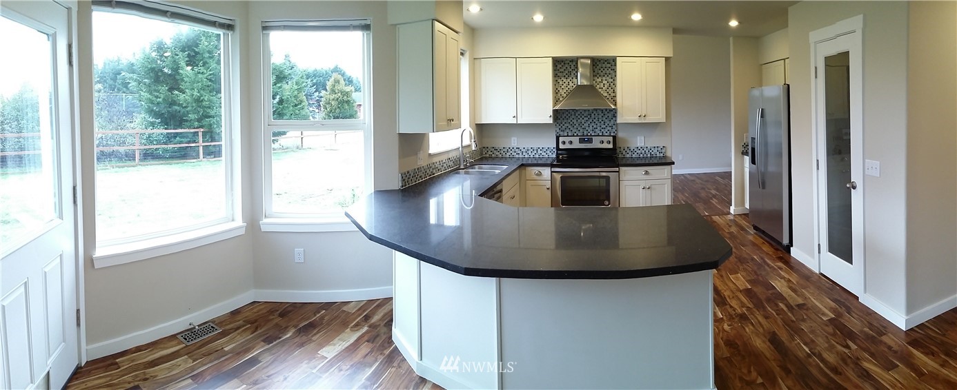 333 Griffith Farm Road Sequim, WA 98382 - Photo 12 of 25 a kitchen with a window a sink and a refrigerator