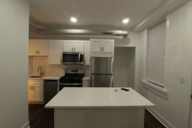 a refrigerator freezer sitting inside of a kitchen