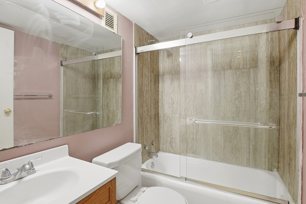 70 Southbridge Street, Unit 310 Worcester, MA 01608 - Photo 12 of 28 a bathroom with a bathtub shower sink and toilet