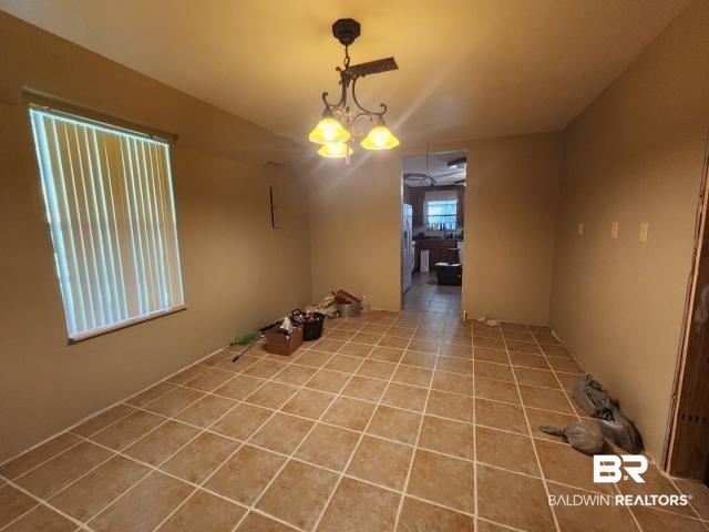 32749 Antietam Road Lillian, AL 36549 - Photo 8 of 47 Tiled empty room featuring a chandelier