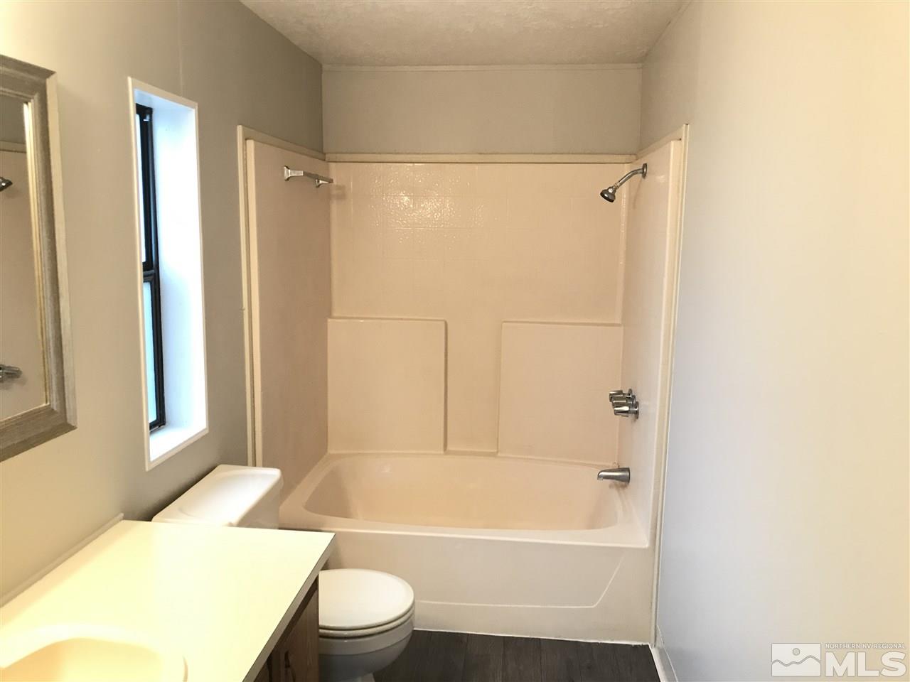 17400 Whippoorwill Lane Reno, NV 89508 - Photo 18 of 18 a bathroom with a toilet and a bathtub
