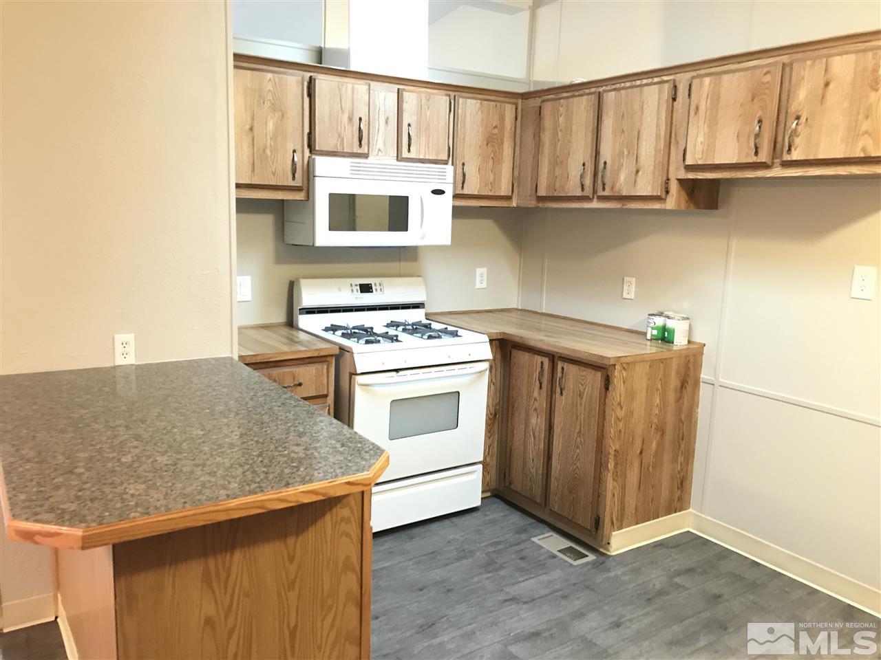 17400 Whippoorwill Lane Reno, NV 89508 - Photo 5 of 18 a kitchen with stainless steel appliances granite countertop a stove a sink and a refrigerator