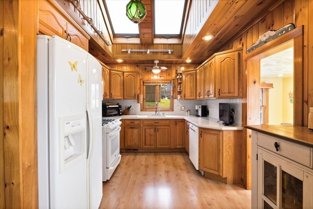 7 Glendale Road Wareham, MA 02558 - Photo 8 of 33 a kitchen with stainless steel appliances granite countertop a refrigerator a sink dishwasher a stove and white countertops with wooden floor
