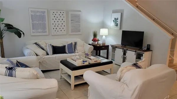 a living room with furniture and a flat screen tv