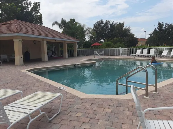 a view of a swimming pool with a lounge chairs
