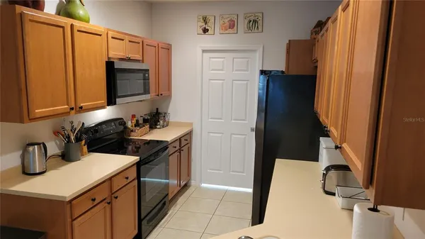 a kitchen with a sink stove and refrigerator