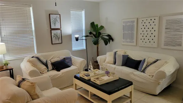 a living room with furniture a rug and a window