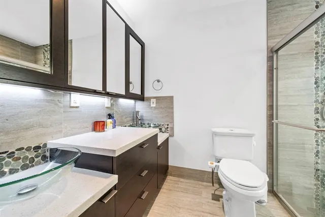 a bathroom with a sink toilet and a mirror