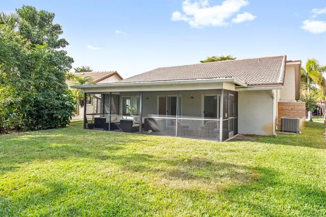 a view of a house with a yard and sitting area