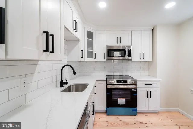 a kitchen with granite countertop a stove and a sink
